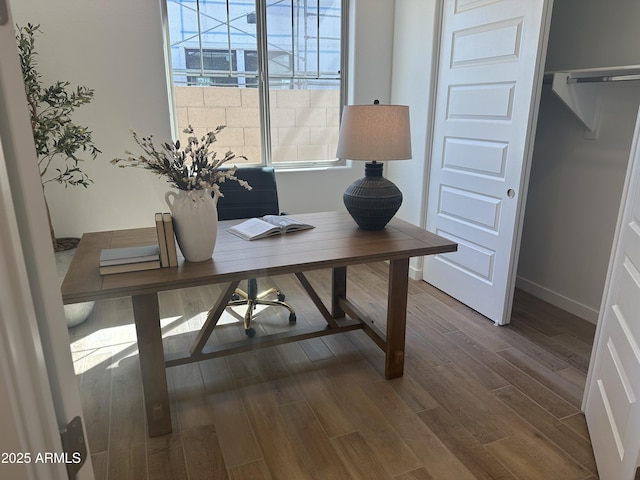 office area featuring plenty of natural light, dark wood-type flooring, and baseboards