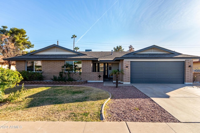 single story home featuring a front yard and a garage