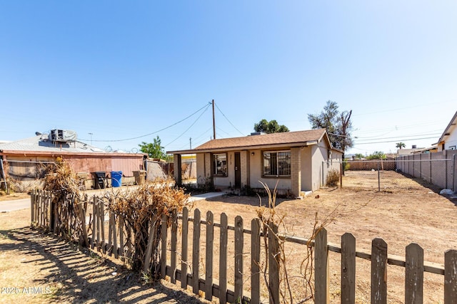 ranch-style home featuring fence private yard