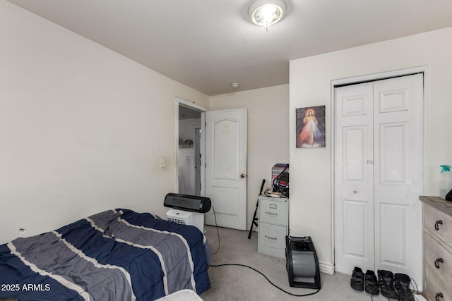 bedroom featuring a closet and light carpet