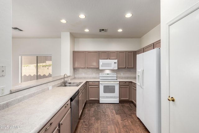2556 W Amber Sun Dr, Phoenix, AZ 85085 - kitchen with white appliances, recessed lighting, tasteful backsplash, dark wood-type flooring, and light countertops