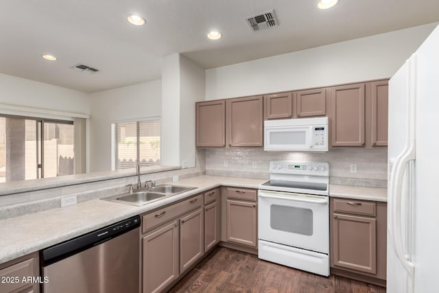 2556 W Amber Sun Dr, Phoenix, AZ 85085 - kitchen featuring white appliances, recessed lighting, light countertops, dark wood-style flooring, and tasteful backsplash