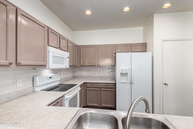 2556 W Amber Sun Dr, Phoenix, AZ 85085 - kitchen with white appliances, light countertops, decorative backsplash, and recessed lighting