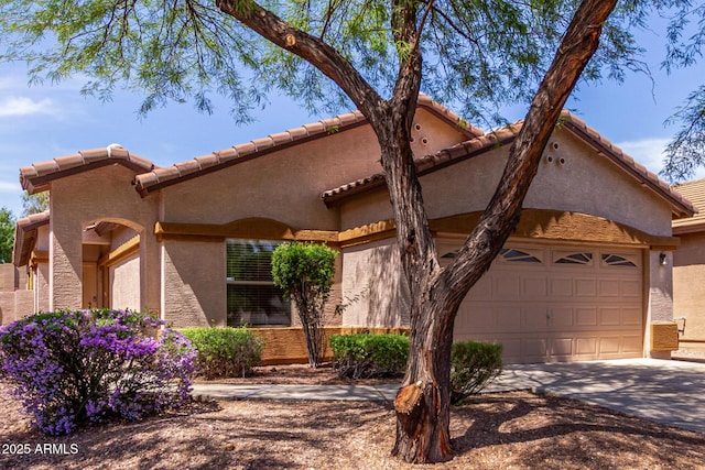 2556 W Amber Sun Dr, Phoenix, AZ 85085 - view of front of property with an attached garage, concrete driveway, a tile roof, and stucco siding