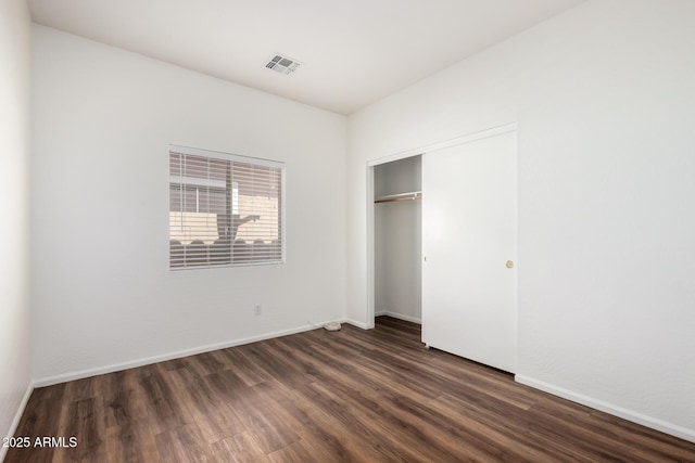2556 W Amber Sun Dr, Phoenix, AZ 85085 - unfurnished bedroom with dark wood finished floors and a closet