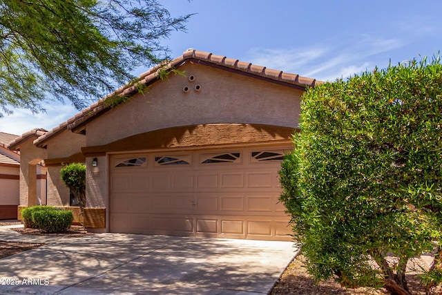2556 W Amber Sun Dr, Phoenix, AZ 85085 - view of front facade with driveway, a tiled roof, a garage, and stucco siding