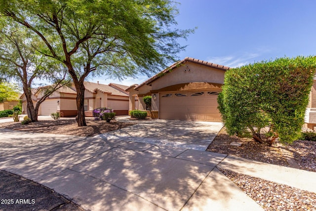 2556 W Amber Sun Dr, Phoenix, AZ 85085 - mediterranean / spanish house featuring an attached garage, driveway, stucco siding, and a tiled roof
