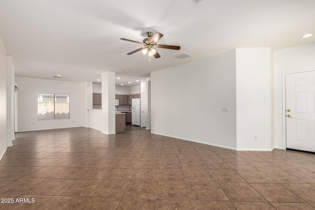 2556 W Amber Sun Dr, Phoenix, AZ 85085 - unfurnished living room featuring a ceiling fan, dark tile patterned floors, and recessed lighting