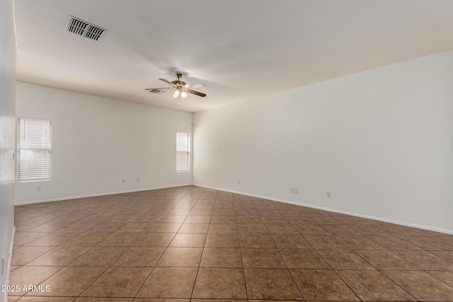 2556 W Amber Sun Dr, Phoenix, AZ 85085 - spare room featuring a ceiling fan and tile patterned floors