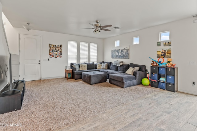 living room featuring ceiling fan, a healthy amount of sunlight, and wood-type flooring