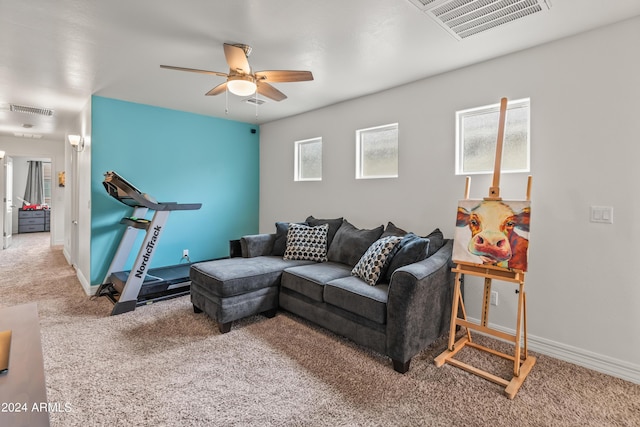 carpeted living room with ceiling fan