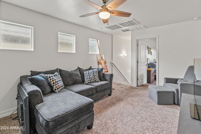 carpeted living room featuring ceiling fan