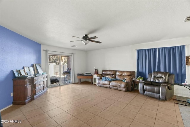 living room featuring light tile patterned floors, ceiling fan, a textured ceiling, and visible vents