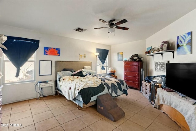 bedroom featuring light tile patterned flooring, ceiling fan, and visible vents