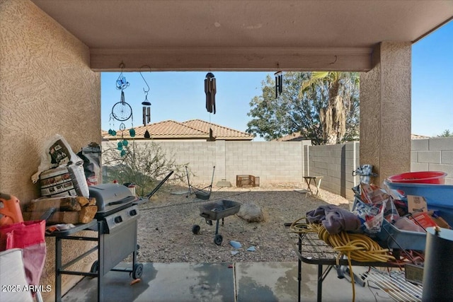 view of patio with a fenced backyard and a grill