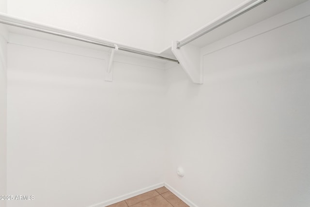 spacious closet featuring light tile patterned flooring