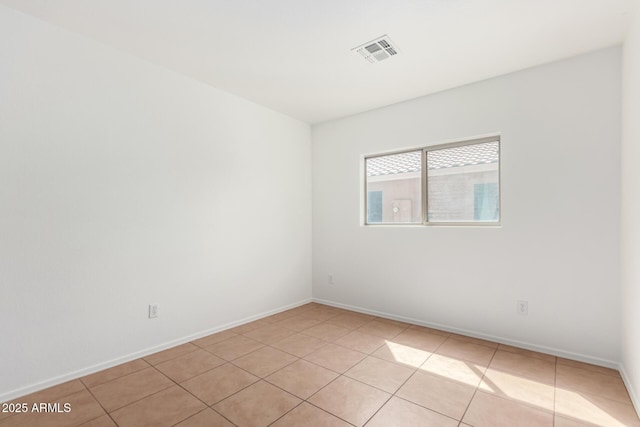 spare room with visible vents, baseboards, and light tile patterned flooring