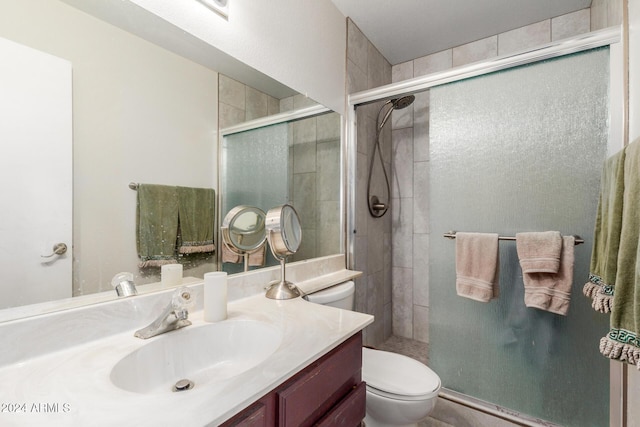 full bath featuring a shower stall, toilet, and vanity