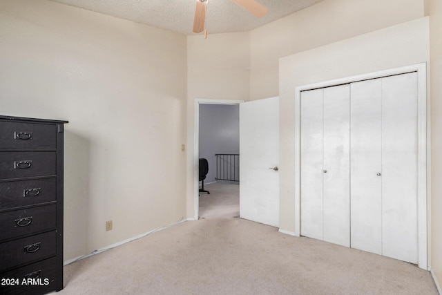 unfurnished bedroom with a closet, carpet flooring, and a textured ceiling