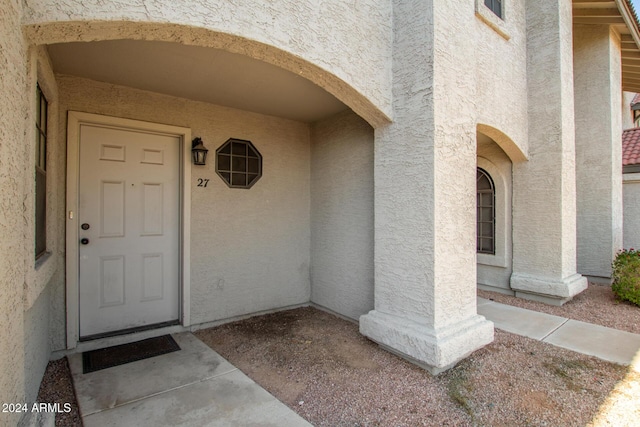 property entrance with stucco siding