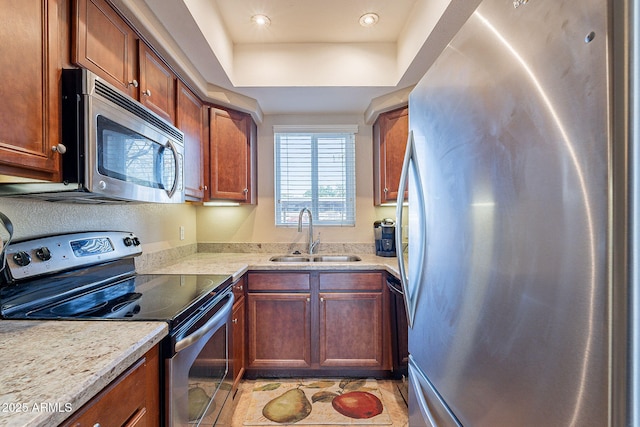 1825 W Ray Rd Unit 1068, Chandler, AZ 85224 - kitchen with light countertops, a tray ceiling, stainless steel appliances, a sink, and brown cabinets