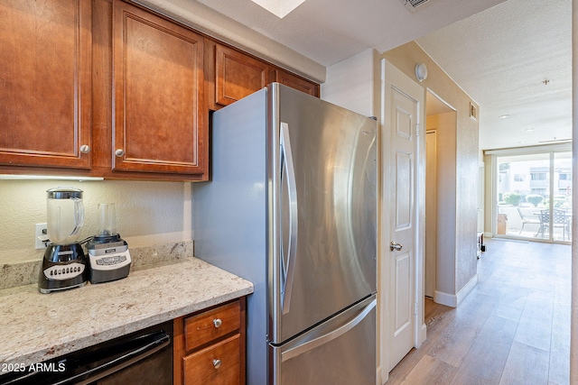 1825 W Ray Rd Unit 1068, Chandler, AZ 85224 - kitchen with freestanding refrigerator, light wood-style flooring, dishwasher, and brown cabinetry