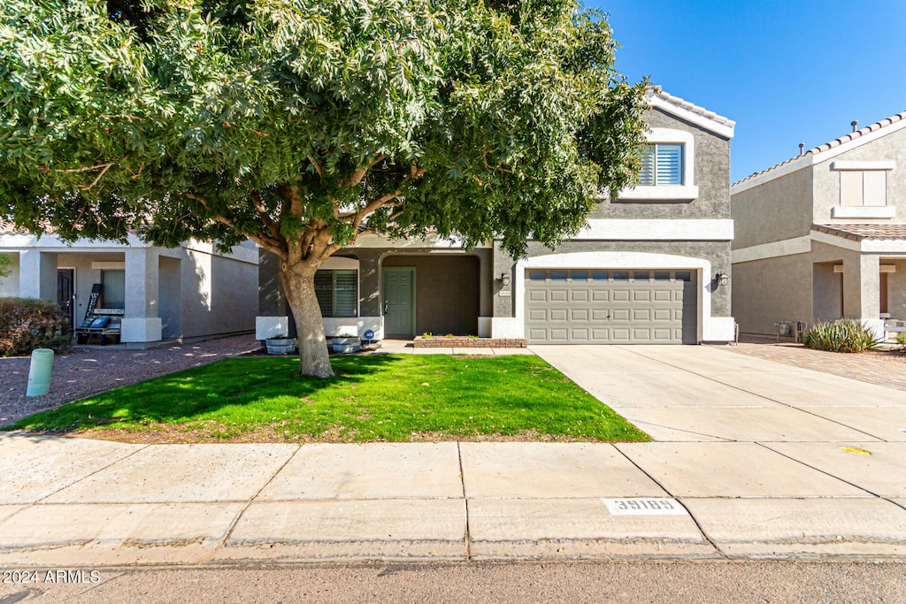 view of property hidden behind natural elements featuring a garage