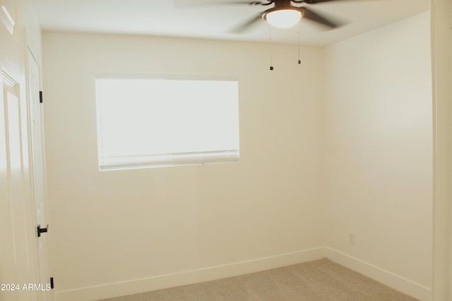 spare room featuring carpet, plenty of natural light, and ceiling fan