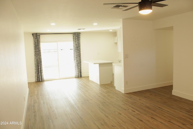 spare room with ceiling fan and wood-type flooring