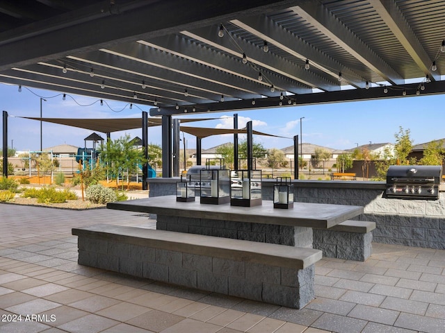 view of patio / terrace featuring area for grilling and a pergola