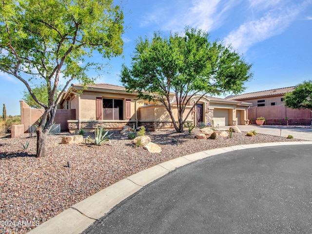 3220 W Feather Sound Dr, Anthem, AZ 85086 - view of front of house featuring stucco siding, stone siding, fence, and an attached garage