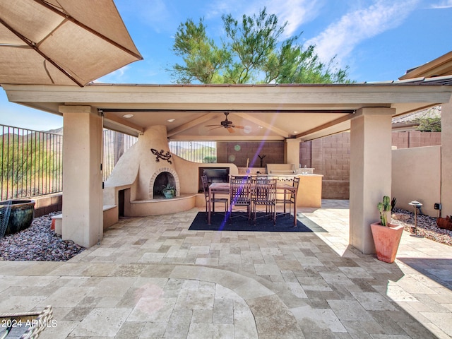 view of patio with ceiling fan and exterior fireplace