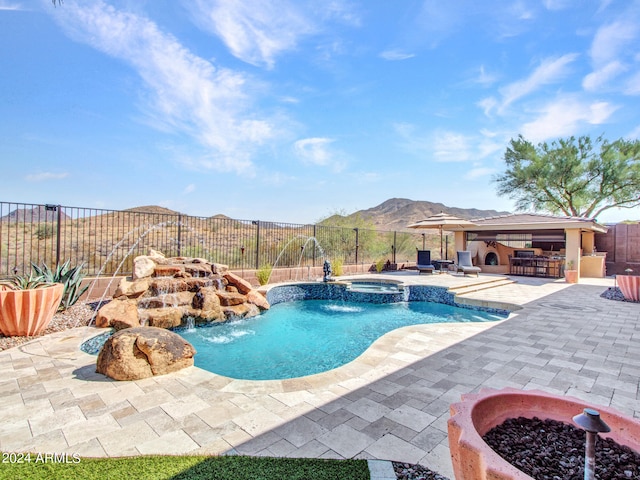 view of pool with a patio, an in ground hot tub, a mountain view, an outdoor bar, and pool water feature