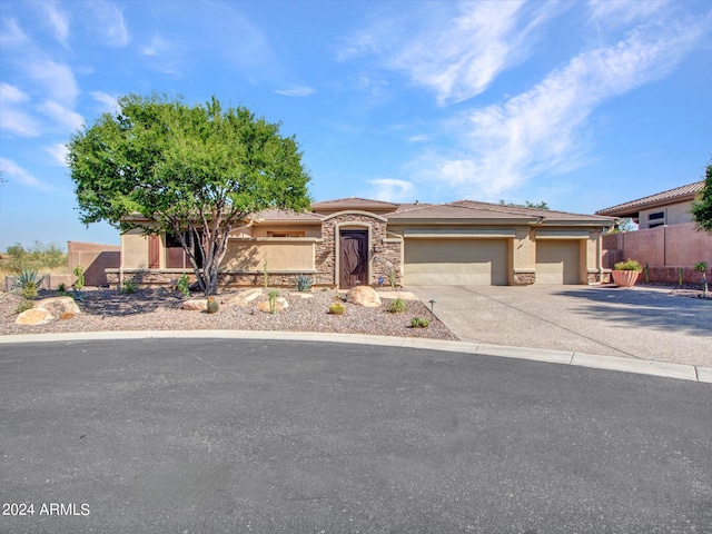 3220 W Feather Sound Dr, Anthem, AZ 85086 - view of front facade featuring stone siding, a garage, stucco siding, and concrete driveway