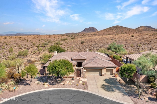 3220 W Feather Sound Dr, Anthem, AZ 85086 - view of front of house with driveway, a mountain view, and an attached garage