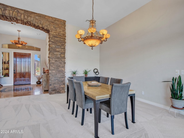 carpeted dining space featuring a notable chandelier