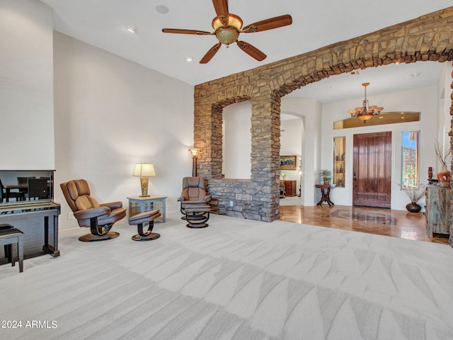 living room with light hardwood / wood-style floors and ceiling fan