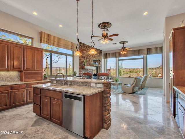 3220 W Feather Sound Dr, Anthem, AZ 85086 - kitchen featuring ceiling fan, an island with sink, a fireplace, dishwasher, and a sink