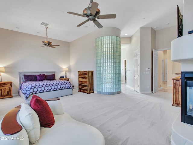 bedroom featuring lofted ceiling, ceiling fan, and light colored carpet