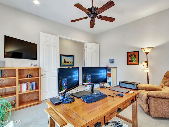 carpeted office space featuring ceiling fan