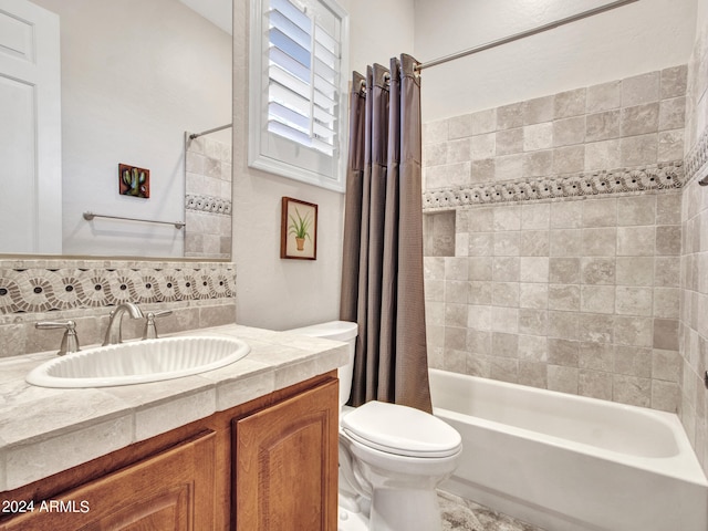 full bathroom with vanity, shower / bath combo with shower curtain, and toilet