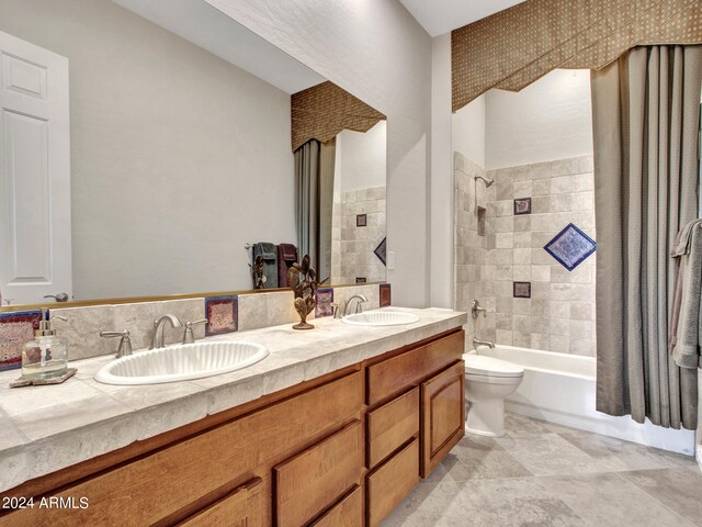 full bathroom with tiled shower / bath, vanity, and toilet