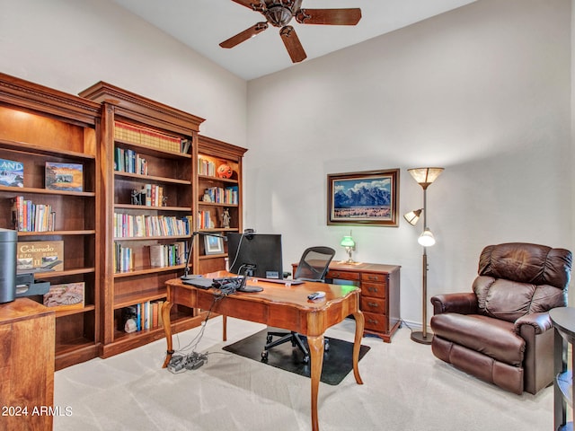 home office featuring light carpet and ceiling fan