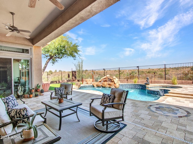 view of pool with ceiling fan, a patio area, an in ground hot tub, and pool water feature