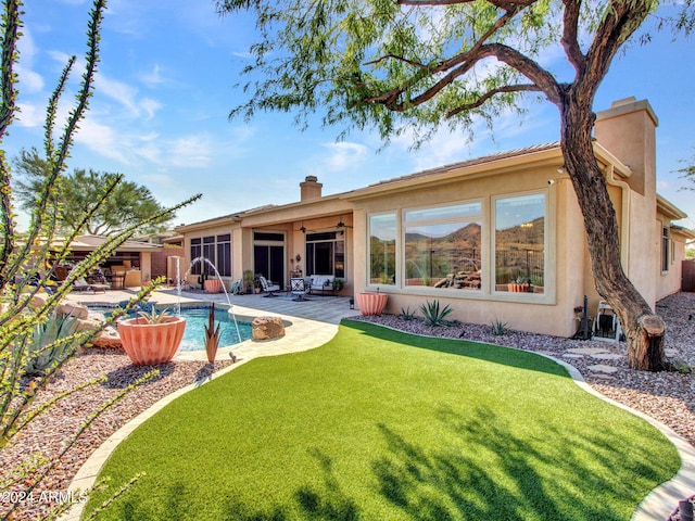 3220 W Feather Sound Dr, Anthem, AZ 85086 - rear view of property featuring a patio area, a ceiling fan, a chimney, stucco siding, and an outdoor pool