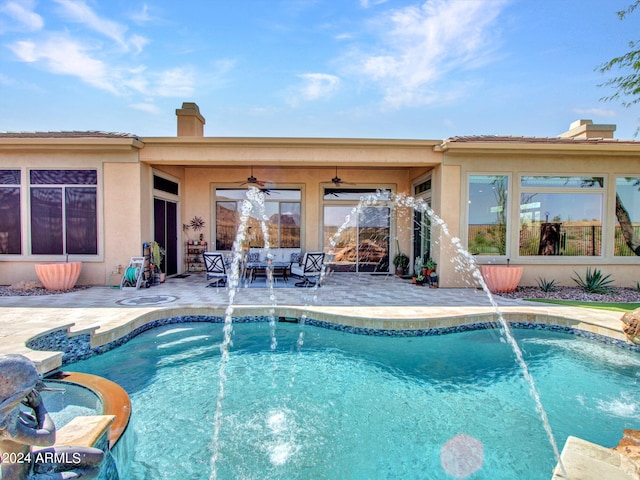 view of swimming pool featuring a patio, ceiling fan, and pool water feature