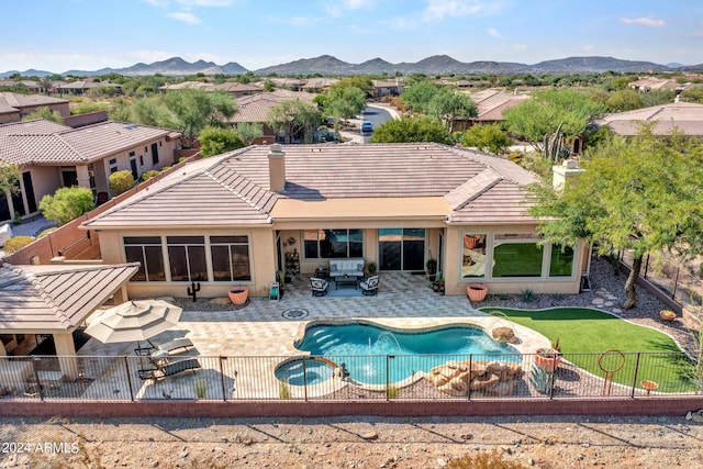 view of pool featuring a mountain view and a patio area