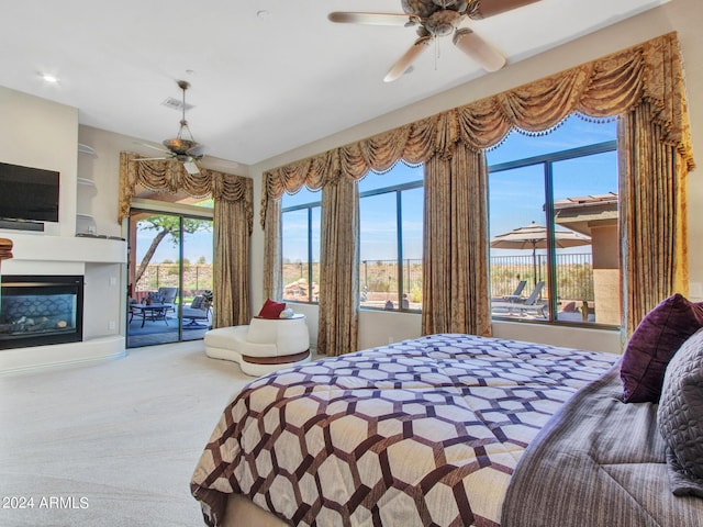 3220 W Feather Sound Dr, Anthem, AZ 85086 - carpeted bedroom with access to exterior, a glass covered fireplace, and visible vents