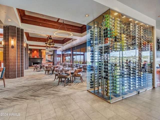 wine room with a raised ceiling and light tile patterned floors