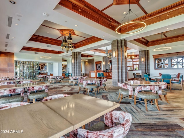 dining space with carpet flooring, a tray ceiling, and ornate columns